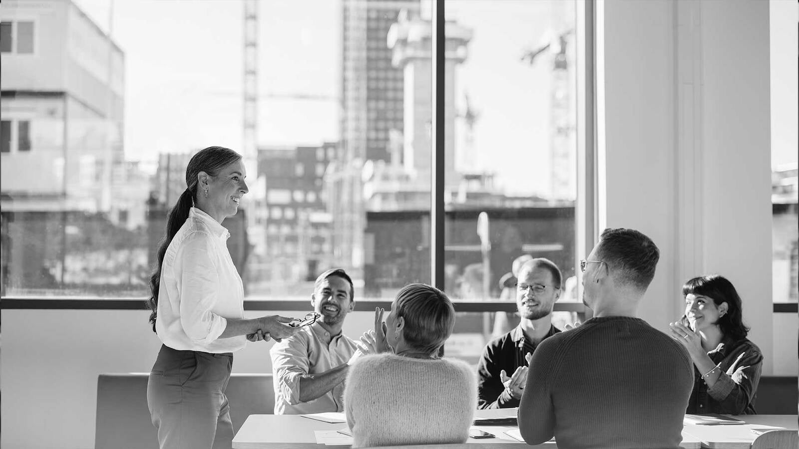 group of business professionals in office space discussing tenant representation services