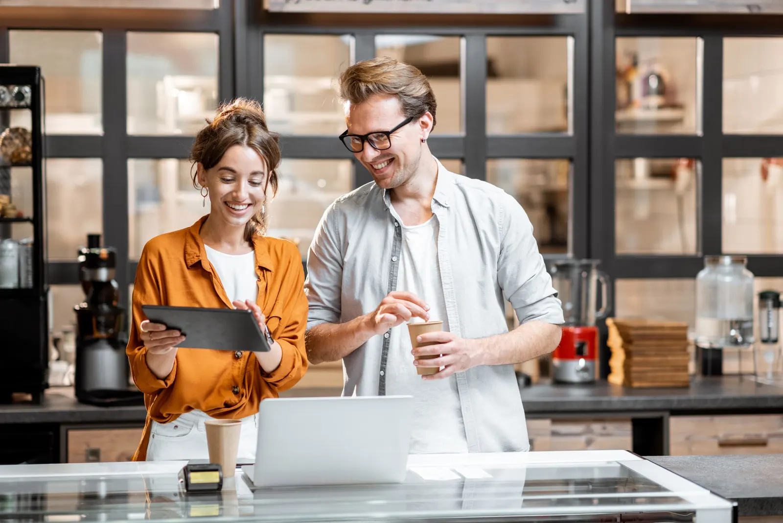Shop owners planning on a tablet